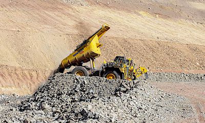 Lindero deposit: Truck dumping ore on coarse ore stockpile