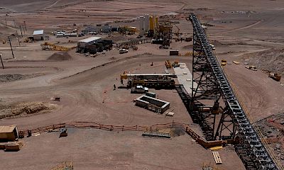 Panoramic view of secondary crusher conveyor belt, stockpile, and agglomeration plant